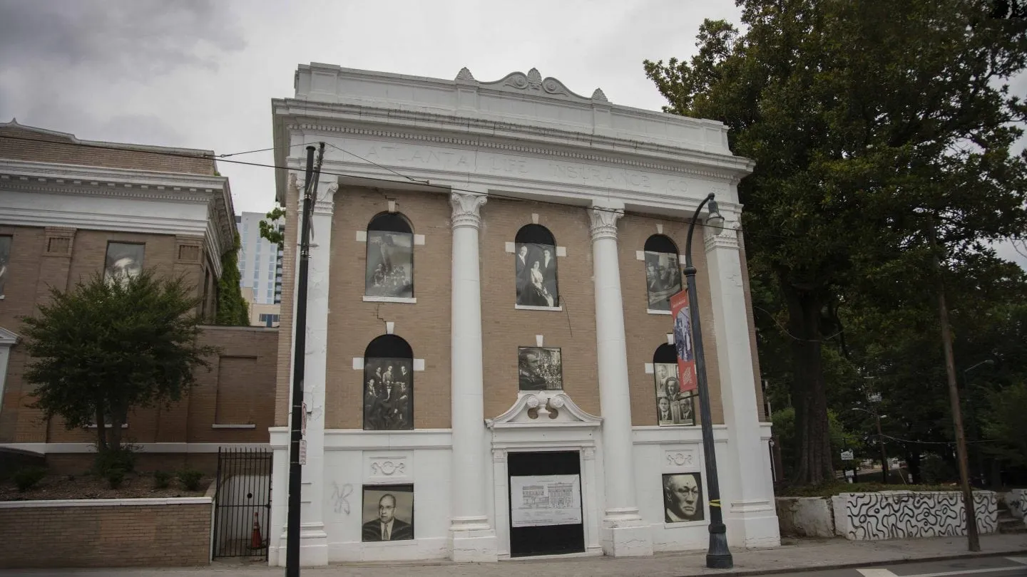 The Atlanta Life Insurance Company building on Auburn Avenue today, its windows filled with portraits from the company's history.