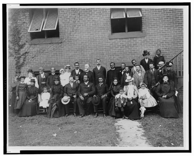 Members of First Congregational Church posed in rows outside the earlier brick church, around 1899.