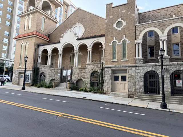 The church from the Courtland Street sidewalk, its arches and tower in afternoon light.