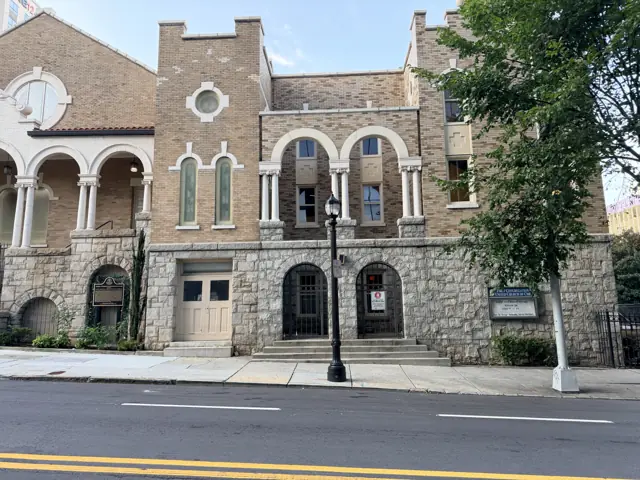 The 1908 stone church at Courtland Street, seen straight on across the street.