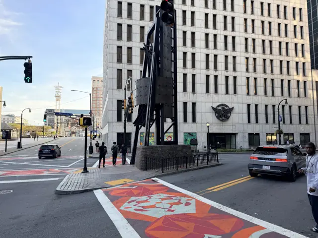 The Flatiron Building at Five Points, seen across the painted intersection.