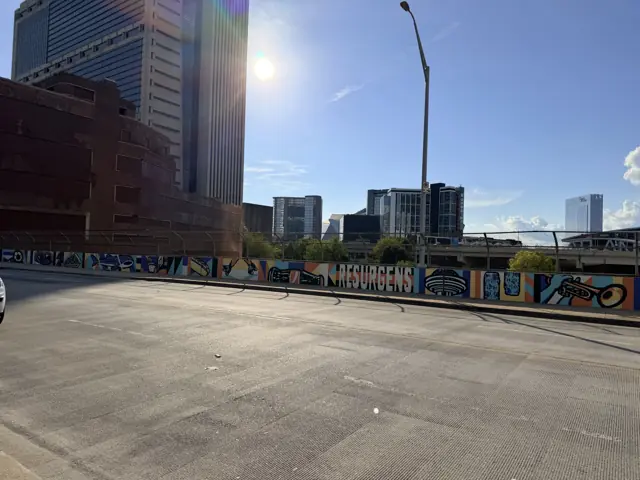 The empty parking lot at 10 Forsyth Street, where the Austell Building stood, a painted fence around it.