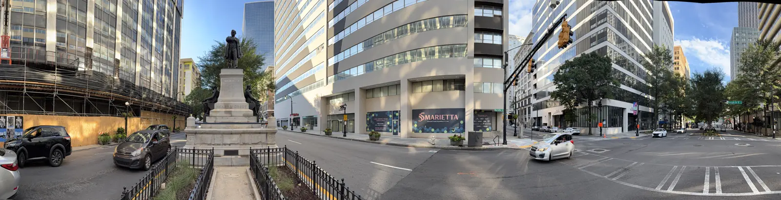 A wide view of Marietta Street with the Grady monument at left and the office buildings at the corner.