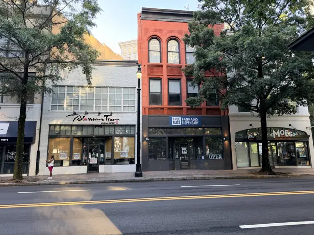 The 66 Peachtree building from across the street, its upper windows arched.