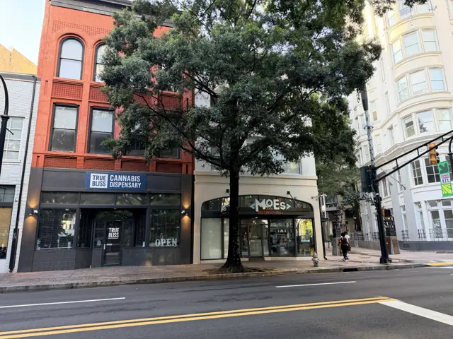 The building at 66 Peachtree from the corner, the Flatiron Building visible beyond.