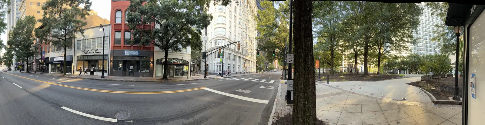 A wide view of Peachtree Street with the 66 Peachtree building on the left and Woodruff Park on the right.