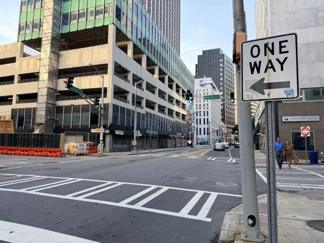 The parking deck on the Kimball House block, seen along Decatur Street looking west, a One Way sign in the foreground.
