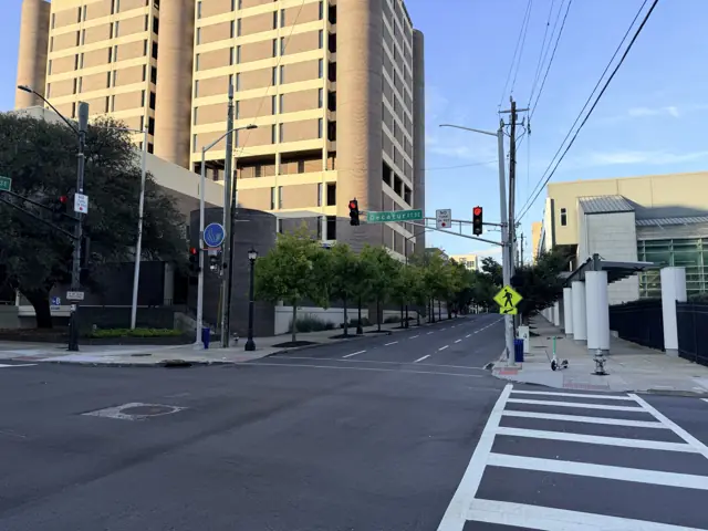 The crosswalk at Decatur Street and Piedmont Avenue, a parking deck and trees ahead.